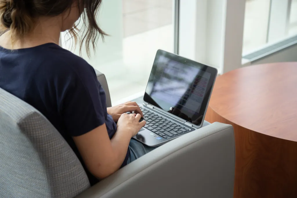 student working on their computer in the university center